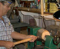 Beau starting a seed pot vase from a log